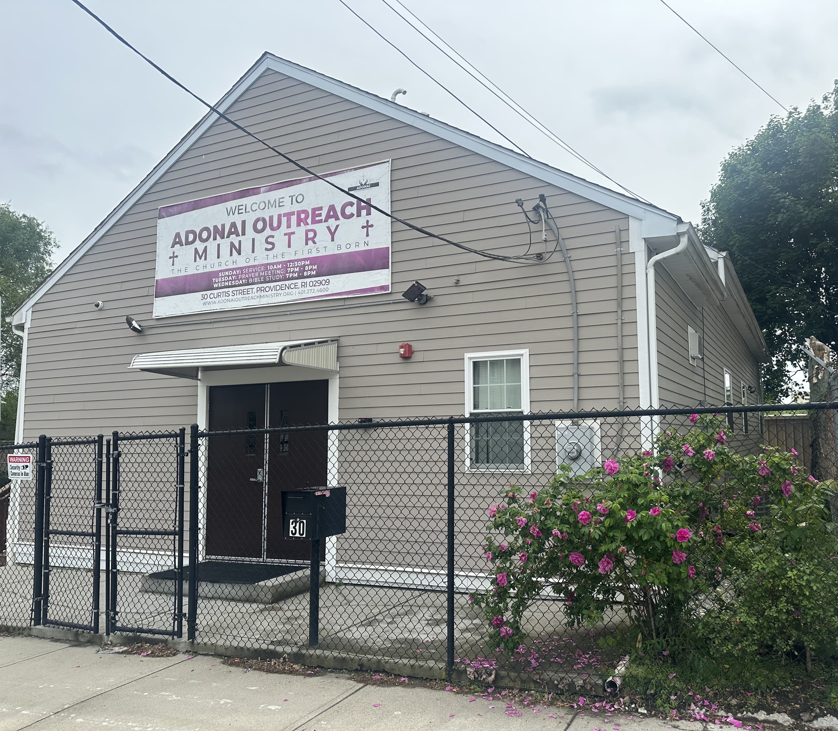The welcoming front entrance of Adonai Outreach Ministry on Curtis Street, with the church name banner above the doors